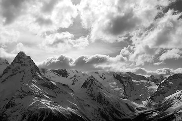 Image showing Black and white view on winter snow mountains and cloud sky in e