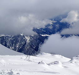 Image showing View on winter snowy mountains in clouds