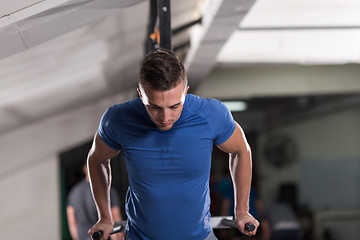 Image showing man doing exercises parallel bars