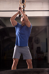 Image showing man workout with hammer and tractor tire