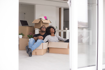 Image showing African American couple  playing with packing material