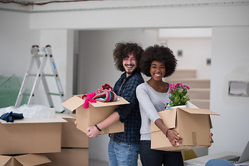 Image showing multiethnic couple moving into a new home