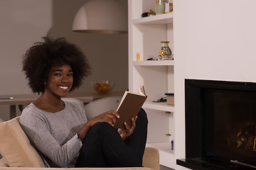 Image showing black woman at home reading book