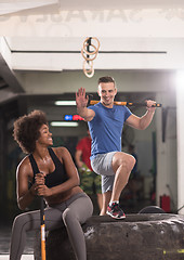 Image showing multiethnic couple after workout with hammer