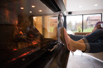 Image showing Young multiethnic couple  in front of fireplace