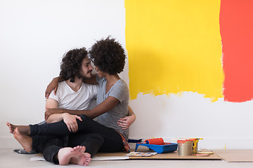 Image showing young multiethnic couple relaxing after painting