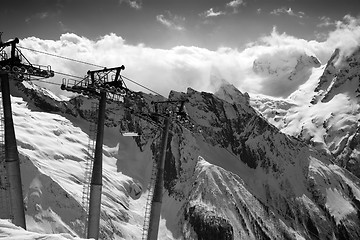 Image showing Black and white view on cable car at ski resort and mountains