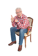 Image showing Senior man sitting surprised.