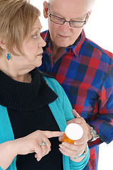 Image showing Wife showing husband his pills.