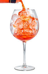 Image showing red aperitif pouring into glass