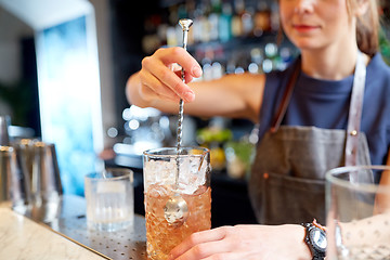 Image showing bartender with cocktail stirrer and glass at bar