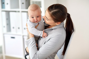 Image showing happy businesswoman with baby at office