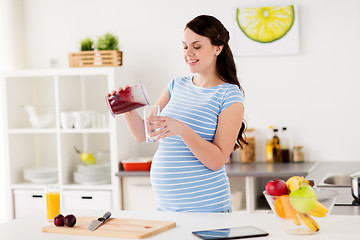 Image showing pregnant woman with blender cup and glass at home