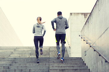 Image showing couple running upstairs on city stairs