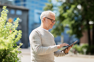 Image showing senior man with tablet pc on city street