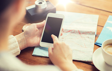 Image showing close up of traveler hands with smartphone and map