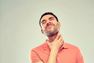 Image showing man touching neck and suffering from throat pain