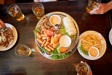 Image showing table with food and beer glasses at bar or pub