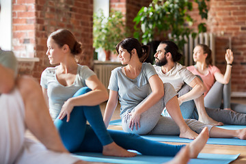 Image showing group of people doing yoga exercises at studio