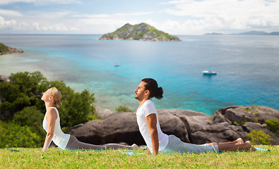 Image showing couple making yoga cobra pose outdoors