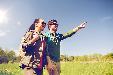 Image showing happy couple with backpacks hiking outdoors