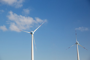 Image showing wind turbines over blue sky
