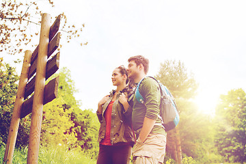 Image showing smiling couple with backpacks hiking