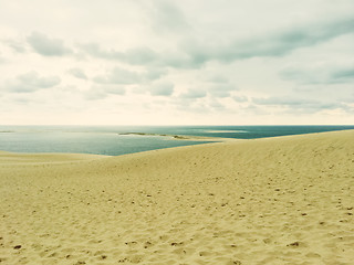 Image showing Sand dunes, sea and cloudy sky