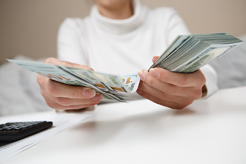 Image showing Hands counting money, close up