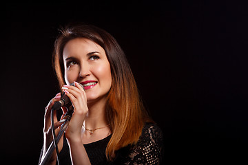 Image showing Singing girl on black background