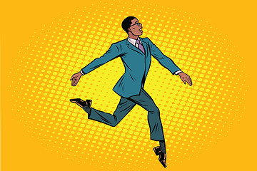 Image showing African businessman runs forward elegantly