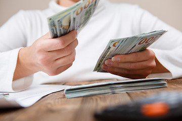 Image showing Hands counting money, close up