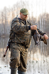 Image showing hunter holding a duck