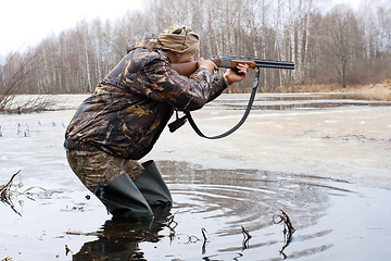 Image showing hunter shooting from a gun
