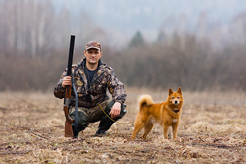 Image showing hunter with dog on the field