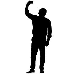 Image showing Silhouettes man taking selfie with smartphone on white background