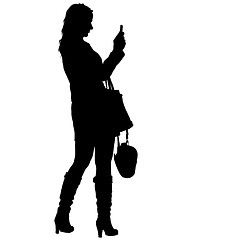 Image showing Silhouettes woman taking selfie with smartphone on white background