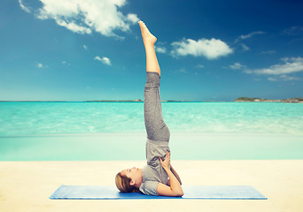 Image showing woman making yoga in shoulderstand pose on mat