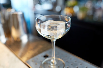 Image showing glass with ice cube at cocktail bar