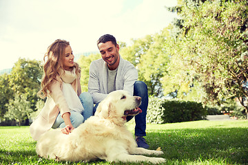 Image showing happy couple with labrador dog walking in city