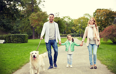 Image showing happy family with labrador retriever dog in park