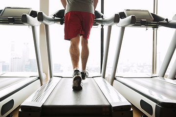 Image showing man exercising on treadmill in gym