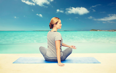 Image showing woman making yoga in twist pose on mat