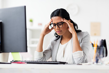 Image showing stressed businesswoman with computer at office