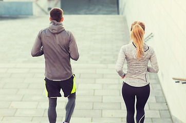 Image showing couple running downstairs on city stairs