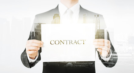 Image showing close up of businessman holding contract paper