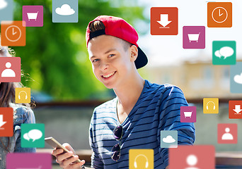 Image showing happy teenage boy with smartphone outdoors