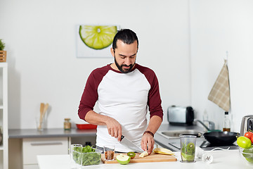 Image showing man with blender and fruit cooking at home kitchen