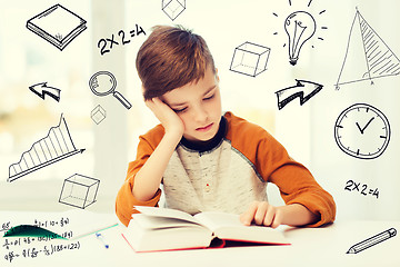 Image showing student boy reading book or textbook at home