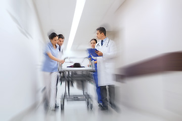 Image showing medics and patient on hospital gurney at emergency